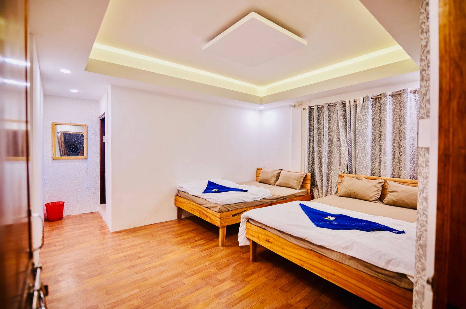 Guest room with two beds and bright windows